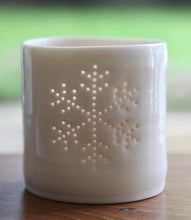 Load image into Gallery viewer, Porcelain ceramic tealight candle holder, glazed in a natural glossy glaze, and pierced with a snowflake design. Christmas gift. Decoration.