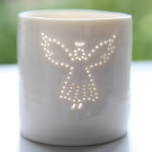 Load image into Gallery viewer, A photo of a ceramic porcelain tealight candle holder featuring a delicately pierced design of an angel with a halo
