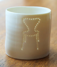 Load image into Gallery viewer, A porcelain tealight candle holder with a design of a midcentury classic chair