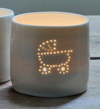 Load image into Gallery viewer, Porcelain ceramic tealight candle holder, glazed in a natural glossy glaze, and pierced with a baby pram design. New baby gift.