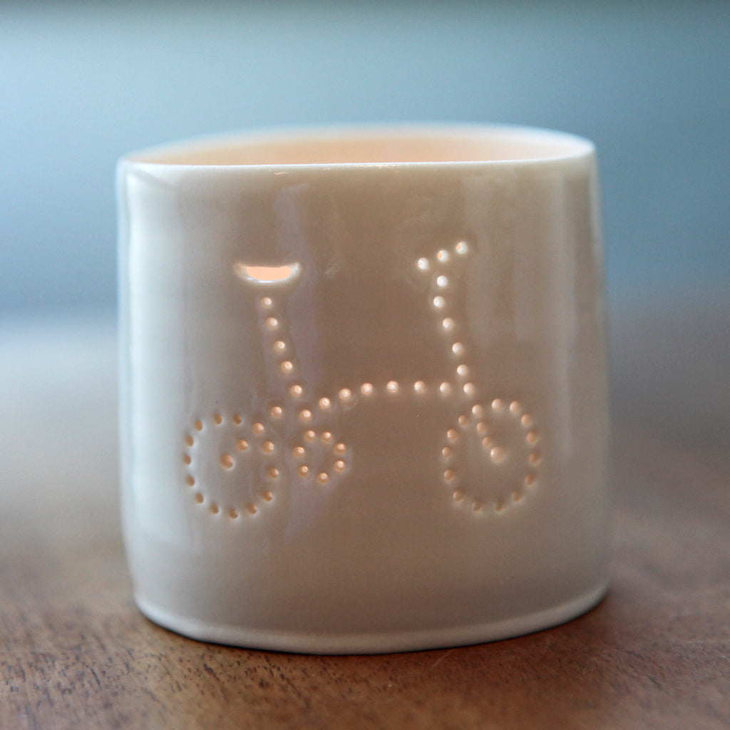 Porcelain ceramic tealight candle holder votive, featuring a design of a folding bike. Natural glossy glaze. Bicycle. Cycling gift. Brompton inspired.