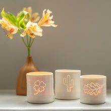 Load image into Gallery viewer, Trio of porcelain tealight candle holders with a cactus, oak leaf and clover design. Outdoor, plant, botanical collection.