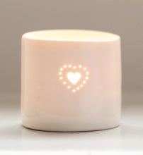 Load image into Gallery viewer, Natural glazed porcelain ceramic tea light candle holder, with a double heart design, pierced with tiny holes. Anniversary wedding valentines gift. Cute lovely present. Glowing in candlelight.