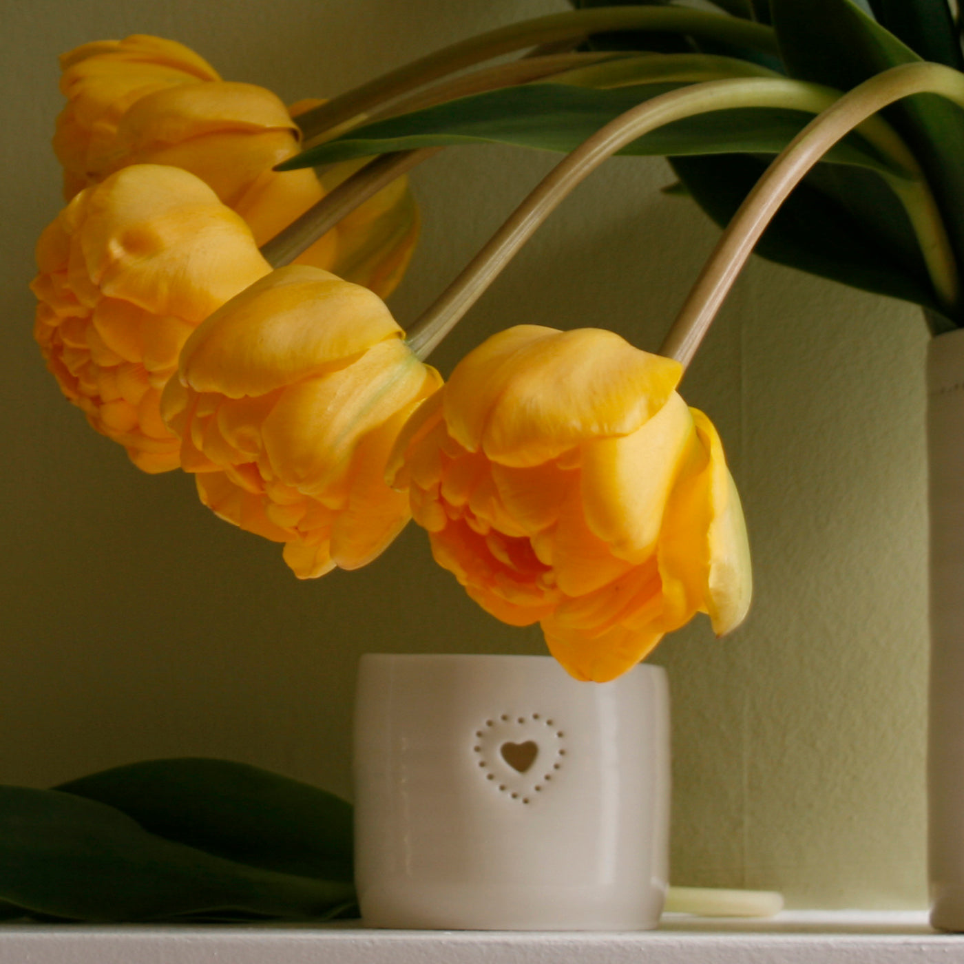 Natural glazed porcelain ceramic tea light candle holder, with a double heart design, pierced with tiny holes. Anniversary wedding valentines gift. Cute lovely present. Mantlepiece flowers.