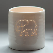 Load image into Gallery viewer, Tropical present. This porcelain ceramic tealight candle holder features a design of an elephant, pierced with tiny holes. Safari present.