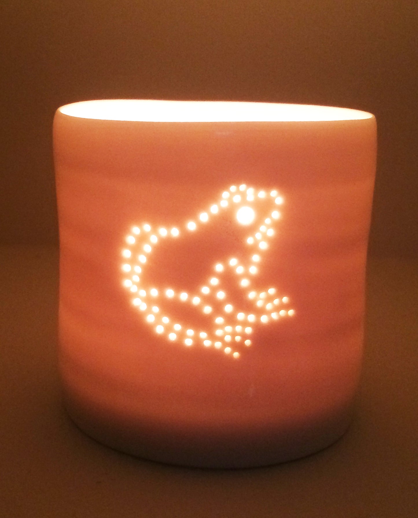 Cute little frog design. Porcelain candle holder with a sitting frog outline in pierced holes. Ceramic tealight holder. Wildlife. Outdoorsy present.