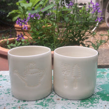 Load image into Gallery viewer, Green fingers present - this ceramic porcelain tealight candle holder features a fork and trowel design, and a watering can. Garden tools. Outdoor lighting. Table decoration. Glossy glaze creates a natural glow.