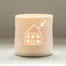 Load image into Gallery viewer, A sweet little house with smoke emerging from the chimney, pierced into a ceramic porcelain tealight holder. This candle votive will create a sense of home, hygge and warmth.