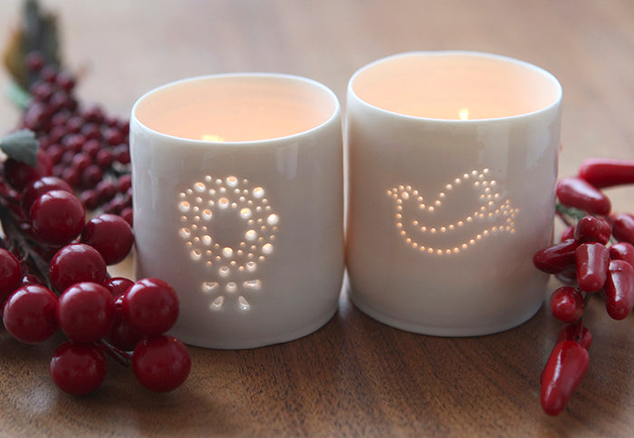 Symbol of peace, one porcelain tealight holder features a dove, and the second features a wreath. Ceramic candle holder with a natural glossy glaze and gentle glow. Christmas decorations. Xmas gifts.