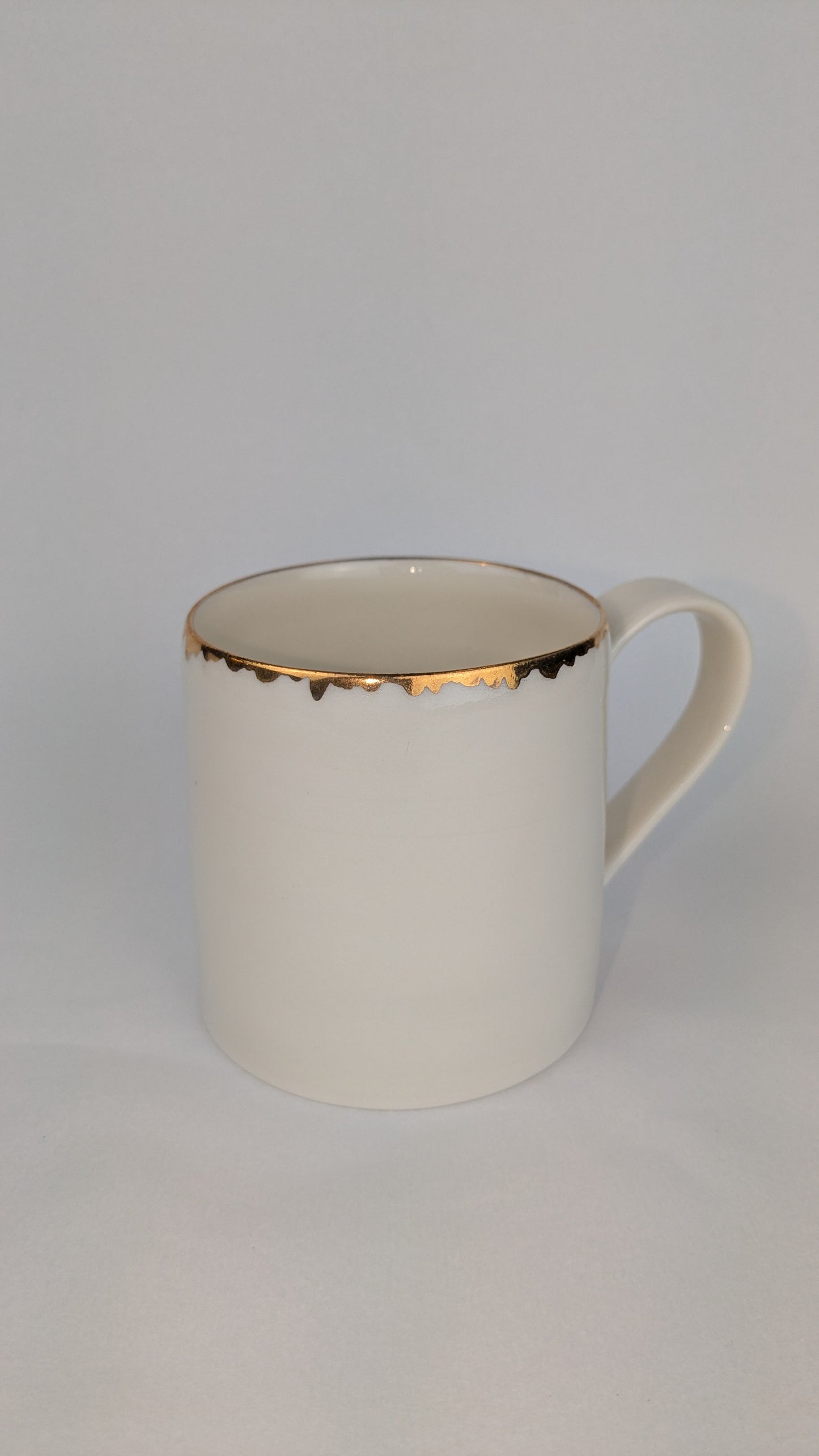 Porcelain cup with gold lustre rim