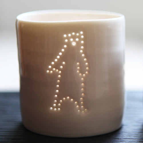 Ceramic porcelain tealight candle holder, votive, natural glossy glaze, and pierced with a standing bear design. Cute gift.