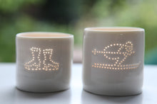 Load image into Gallery viewer, Ice skating, this ceramic porcelain tealight candle holder is a wintery treat. Homeware, Christmas and decoration. Next to a tealight holder featuring a skier design.
