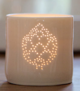 Ceramic porcelain tealight candle holder, featuring a design of an artichoke, pierced into the tealight holder with little holes. Foodie gift.
