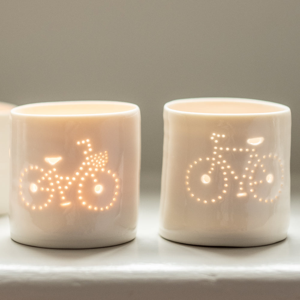 A pair of porcelain ceramic tealight candle holder votive, featuring a design of a bike with a basket and a crossbar. Natural glossy glaze. Bicycle. Cycling gift. Couples gift.