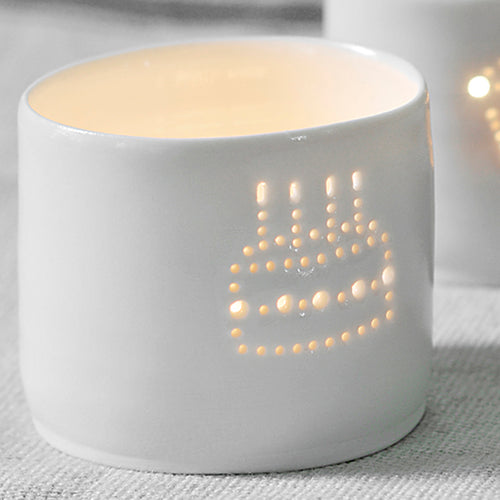 Porcelain ceramic tealight candle holder, featuring a design of a birthday cake with candles, natural glossy glaze. Birthday present. Celebration.