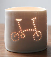 Load image into Gallery viewer, Porcelain ceramic tealight candle holder votive, featuring a design of a folding bike. Natural glossy glaze. Bicycle. Cycling gift. Brompton inspired.
