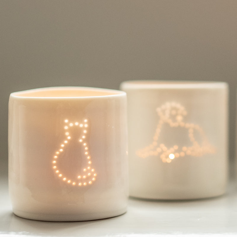 Porcelain ceramic tealight candle holder votive with sitting cat outline design, and dog design in background. Natural glossy glaze. Pet lover. Pet gift.