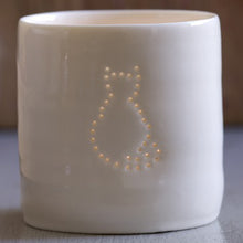 Load image into Gallery viewer, Porcelain ceramic tealight candle holder votive with sitting cat outline design. Natural glossy glaze. Pet lover. Pet gift.
