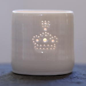Ceramic porcelain tealight candle holder, with a crown design pierced with tiny holes. The crown is a symbol of the king and queen. Perfect for jubilee celebrations and for the kings and queens in your life.