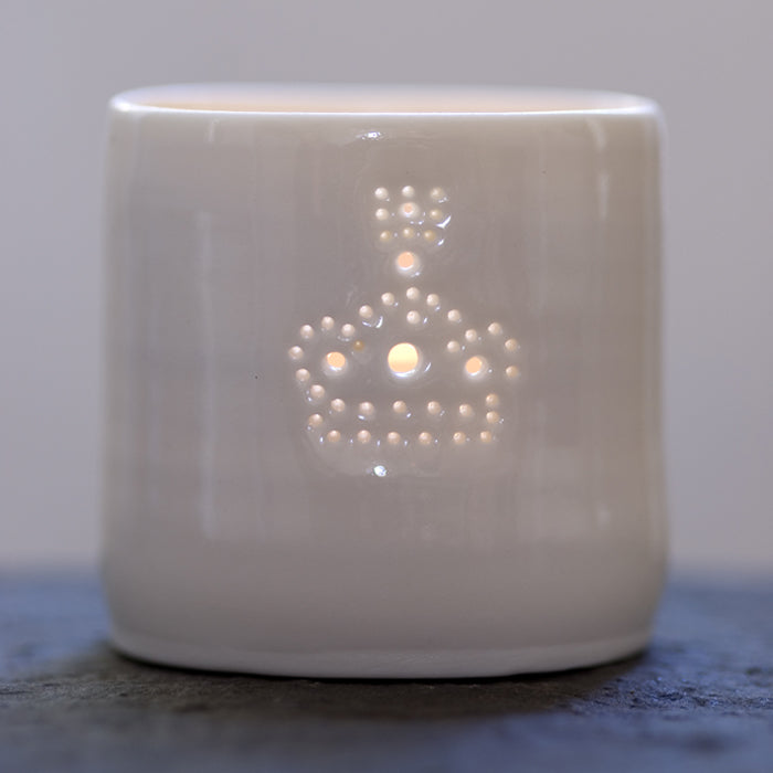 Ceramic porcelain tealight candle holder, with a crown design pierced with tiny holes. The crown is a symbol of the king and queen. Perfect for jubilee celebrations and for the kings and queens in your life.