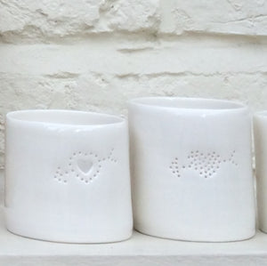 Two porcelain ceramic tealight candle holders with a design of an arrow through a heart. Valentine's Day gift. Romantic present. Anniversary.