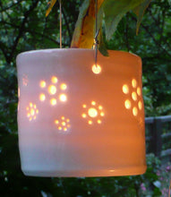 Load image into Gallery viewer, A natural porcelain ceramic tealight candle holder, with a floral design, resembling a field full of flowers. Garden decoration. Outdoor lighting.
