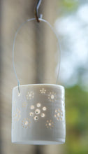 Load image into Gallery viewer, A natural porcelain ceramic tealight candle holder, with a floral design, resembling a field full of flowers. Garden decoration. Outdoor lighting.
