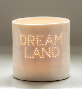 A handmade porcelain tealight holder. This ceramic candle holder spells out the word "dream land". Small business. Relaxing candles. Uplifting gift.