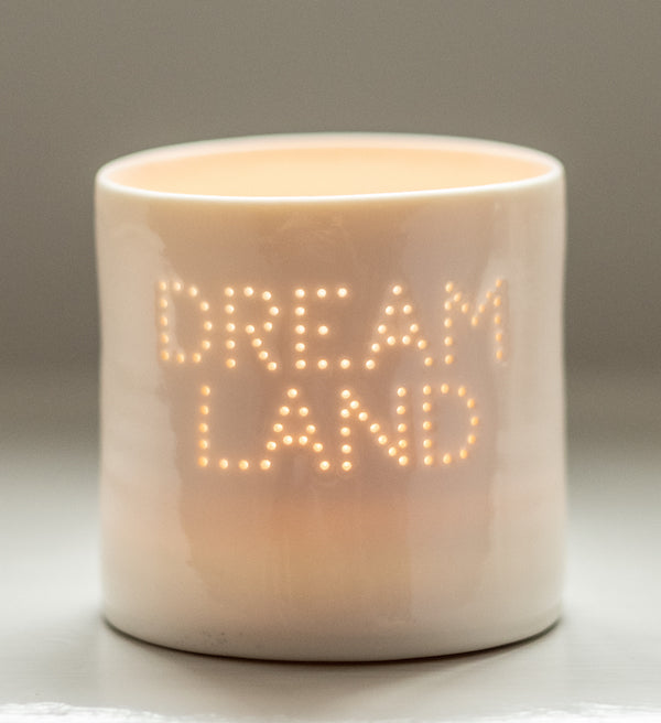 A handmade porcelain tealight holder. This ceramic candle holder spells out the word 