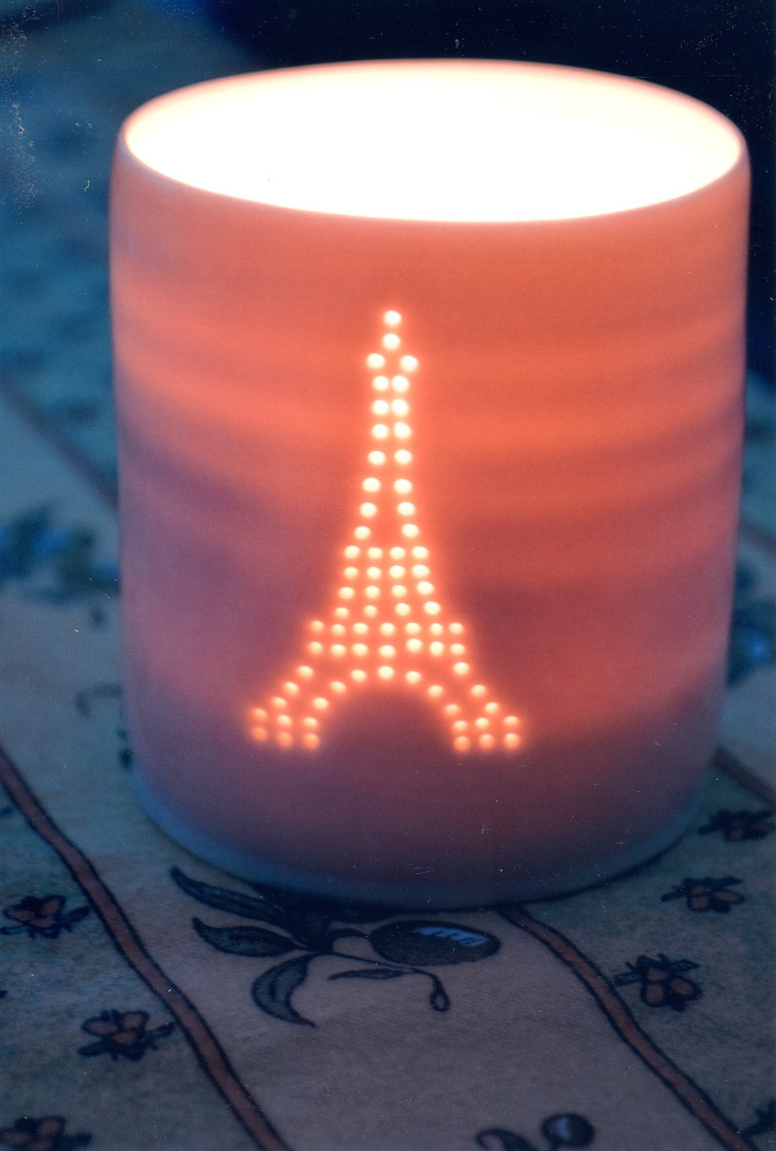 Classic Eiffel Tower design. Porcelain candle holder, this ceramic tealight votive features a classic Paris design.