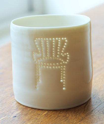 A porcelain tealight candle holder with a design of a midcentury classic chair. Ceramic candle holder. Homeware. Design. Interiors