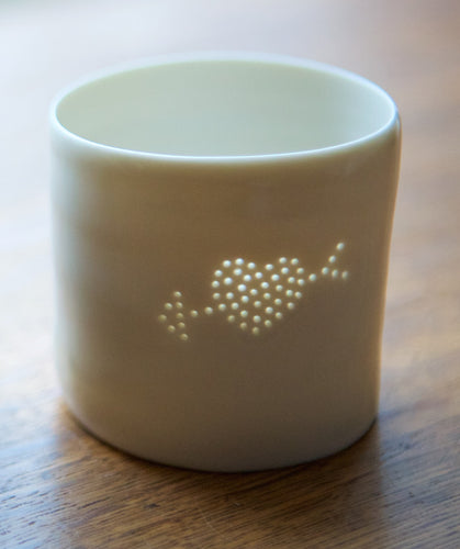 Porcelain ceramic tealight candle holder with a design of an arrow through a filled heart. Valentine's Day gift. Romantic present. Anniversary.