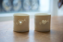 Load image into Gallery viewer, Porcelain ceramic tealight candle holder with a design of an arrow through a filled heart. Valentine&#39;s Day gift. Romantic present. Anniversary.
