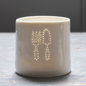 A gardener's present - this ceramic porcelain tealight candle holder features a fork and trowel. Garden tools. Outdoor lighting. Table decoration.