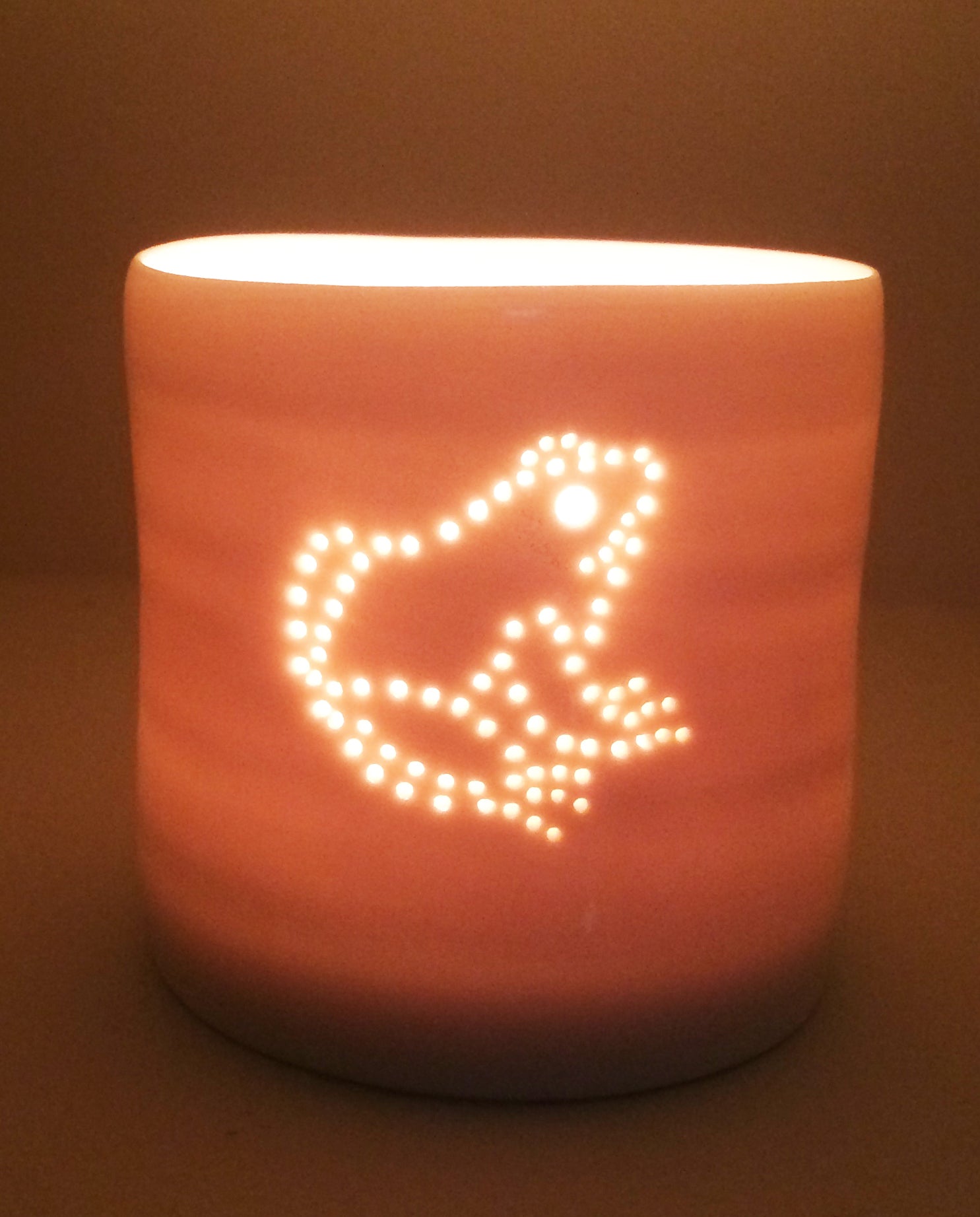 Cute little frog design. Porcelain candle holder with a sitting frog outline in pierced holes. Ceramic tealight holder. Wildlife. Outdoorsy present.