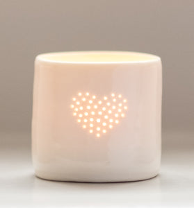 A lovely present this ceramic candle holder is designed with a heart. Porcelain tealight holders as wedding presents, memorials or anniversary gifts.