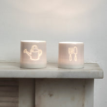 Load image into Gallery viewer, Green fingers present - this ceramic porcelain tealight candle holder features a fork and trowel design, and a watering can. Garden tools. Outdoor lighting. Table decoration. Glossy glaze creates a natural glow.
