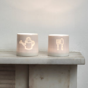 Green fingers present - this ceramic porcelain tealight candle holder features a fork and trowel design, and a watering can. Garden tools. Outdoor lighting. Table decoration. Glossy glaze creates a natural glow.