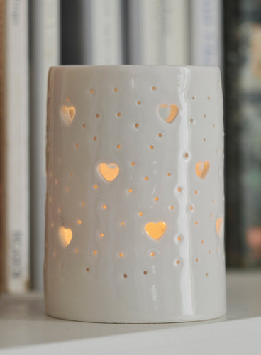 Ceramic tealight holder, glossy natural glaze, with hearts design. Porcelain candle holder for homeware, decoration, or garden.