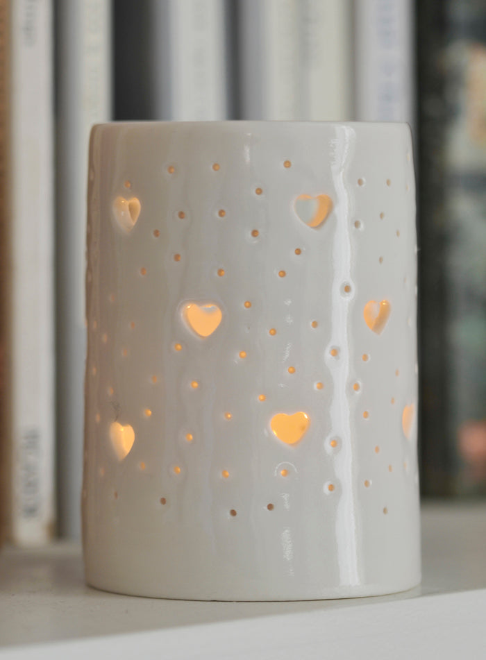 Ceramic tealight holder, glossy natural glaze, with hearts design. Porcelain candle holder for homeware, decoration, or garden.