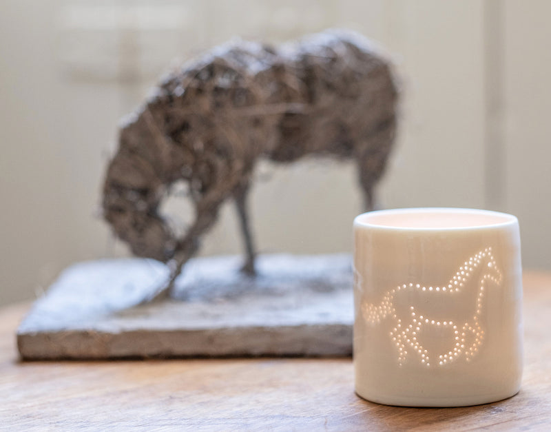 Galloping horse ceramic tealight holder. This porcelain candle holder features an equestrian design, perfect for horse lovers.