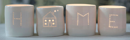 A perfect housewarming present, this set of four candle holders spells out HOME. These porcelain tealight holders create a flickering sense of calm and relaxation.