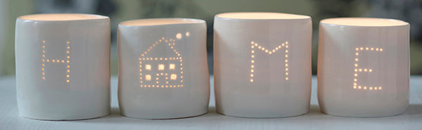 A perfect housewarming present, this set of four candle holders spells out HOME. These porcelain tealight holders create a flickering sense of calm and relaxation.