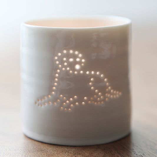 A ceramic tealight holder with a design of a Labrador lying down. This porcelain candle holder is simple and scandi chic.