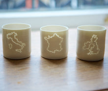 Load image into Gallery viewer, Italy present. Italy country outline on a porcelain candle holder. This ceramic tealight holder evokes European holidays. Handmade. Natural.

