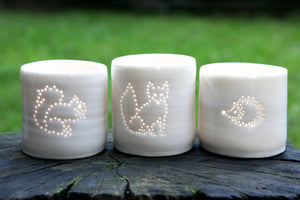Porcelain tealight holders, these ceramic candle holders feature classic urban wildlife, including a squirrel, fox and cute hedgehog. Animals present.